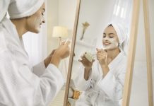 Smiling girl after shower do morning beauty face procedures, take care of skin. Skincare and cosmetology concept.