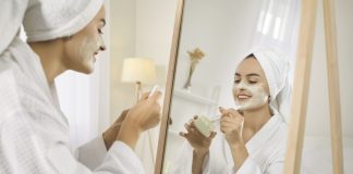 The Small Beauty Rituals that Make Skincare Feel More Personal Smiling girl after shower do morning beauty face procedures, take care of skin. Skincare and cosmetology concept.