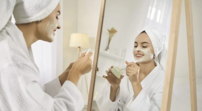 The Small Beauty Rituals that Make Skincare Feel More Personal Smiling girl after shower do morning beauty face procedures, take care of skin. Skincare and cosmetology concept.