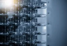 Beyond the Quote: How to Evaluate Injection Molding Suppliers Close up scene of injection process group of preform shape of PET bottle products in the blue scene.