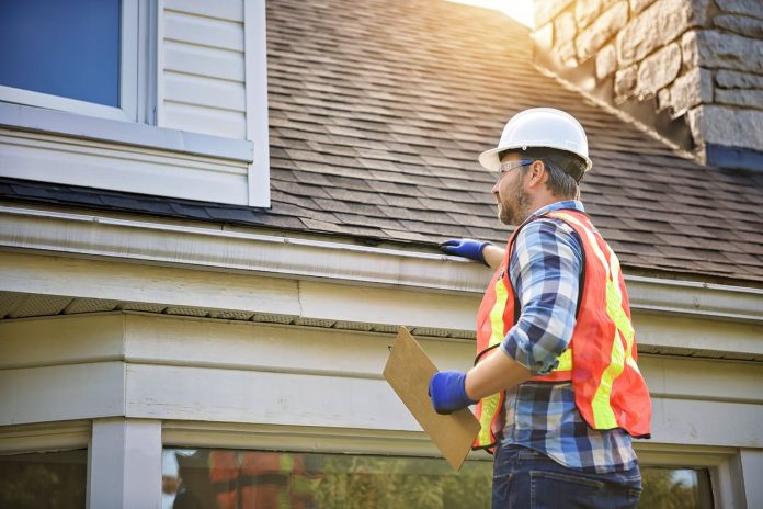 How Roof Design Shapes Home Value - inspecting house roof