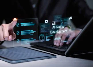 Software developer using laptop and tablet for AI-native development.