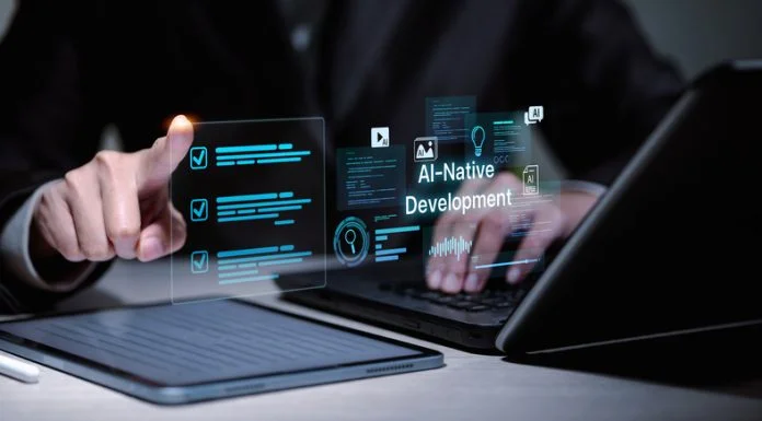AI-Native MVPs: How UK Startups are Cutting Build Time From Months to Weeks Software developer using laptop and tablet for AI-native development.