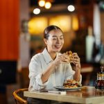 Woman eating in her Favourite Restaurant that Feels Like Home