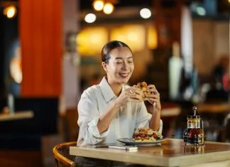 Woman eating in her Favourite Restaurant that Feels Like Home