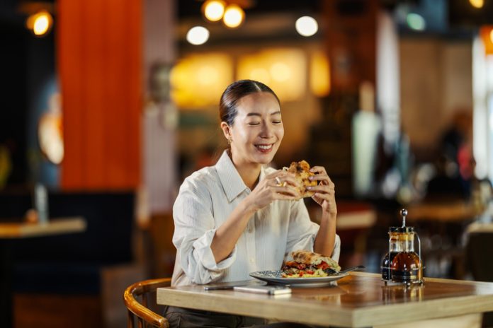 Woman eating in her Favourite Restaurant that Feels Like Home