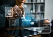 Why European Businesses are Reassessing Their E-Signature Providers in 2026 Business professional reviewing and signing a digital contract on a laptop with electronic document workflow interface, representing e-signature, approval process, compliance,and paperless management.