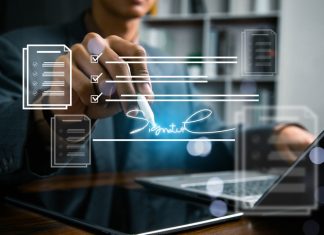 Business professional reviewing and signing a digital contract on a laptop with electronic document workflow interface, representing e-signature, approval process, compliance,and paperless management.