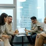 Diverse group of business professionals collaborating in a modern office meeting