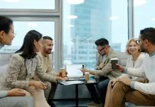 Diverse group of business professionals collaborating in a modern office meeting