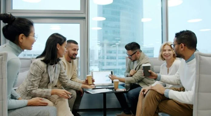 Diverse group of business professionals collaborating in a modern office meeting