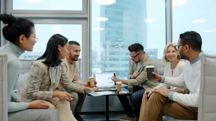 vitaly-gariev-YyJNda7nsPo-unsplash (1) Diverse group of business professionals collaborating in a modern office meeting
