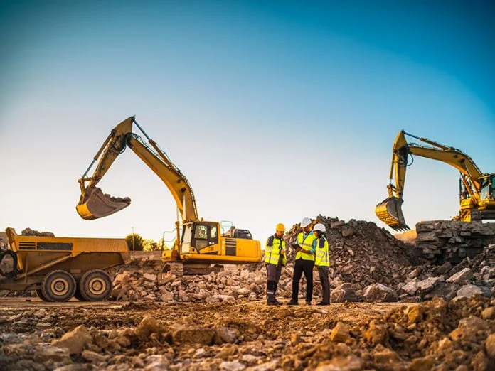Construction Site With Excavators on Sunny Day: Diverse Team Of EPC