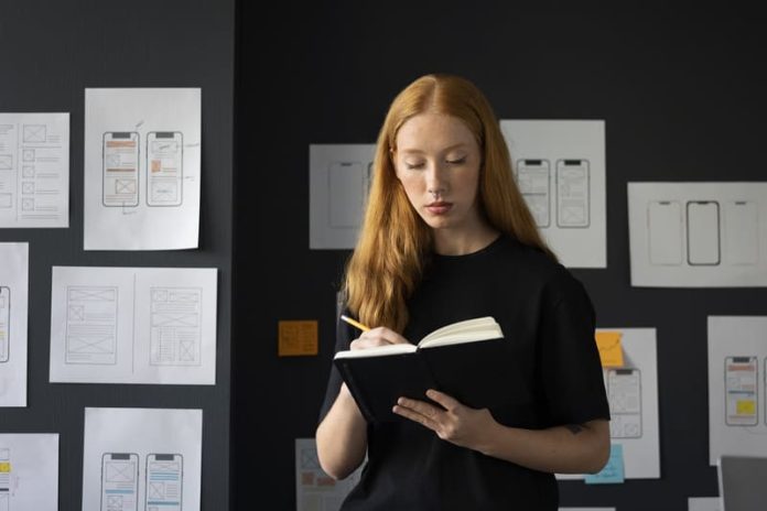 female-web-designer-office-with-notebook (1) (1) Derribar Ventures Limited