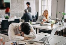 The Business Case for Fixing Presenteeism: Soft Skills, Hard Returns Presenteeism - Overworked businessman taking a break from work and napping on his desk.