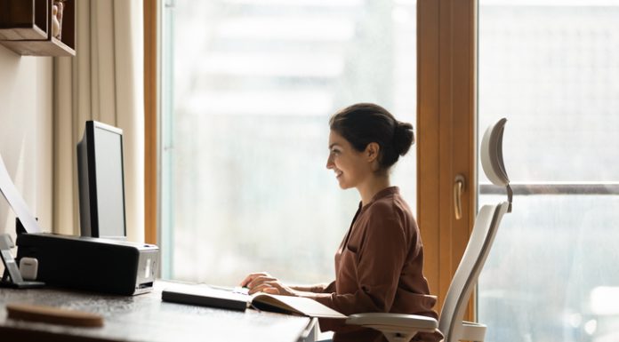 Why Better Ergonomics is One of the Smartest Business Investments Happy successful millennial indian ethnic business lady working in modern home office, using computer software applications, Ergonomics, creating new internet project, communicating distantly with client.