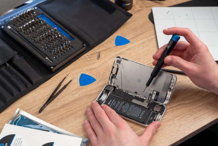 iStock-1461170248 (1) Phone Repair Industry - repairs an iPhone