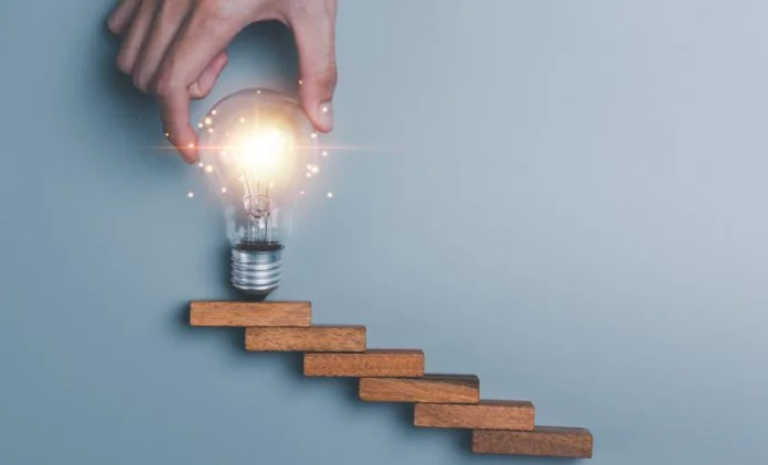 light bulb in human hand, business growth success concept, Ideas for progress in development with strategies and clear goals, development planning for growth systematically early-stage innovation