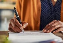 Cheap and Cheerful or Built to Last? Choosing the Right Pen for the Job Close up of african american business woman hand writing on report while working in office. Successful black businesswoman signing documents at home using a pen.
