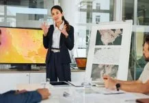 Presentation, Private Sector and map with team for weather pattern, seasonal trends and marketing geography. Whiteboard, meeting and speaker in office with screen, climate data and global campaign