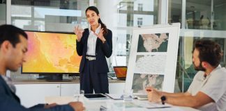 Presentation, Private Sector and map with team for weather pattern, seasonal trends and marketing geography. Whiteboard, meeting and speaker in office with screen, climate data and global campaign
