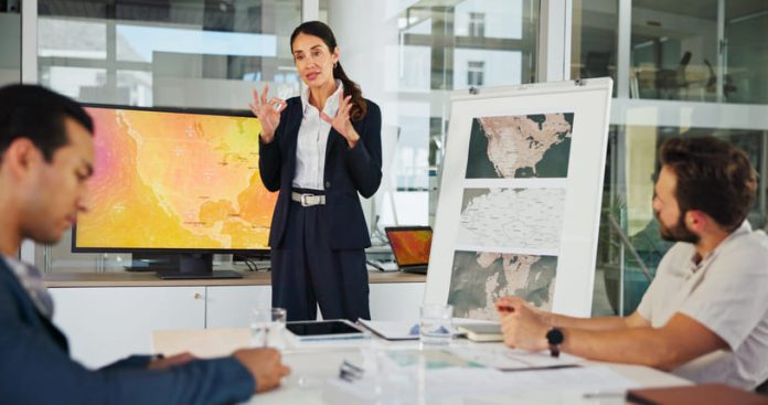 iStock-2216502431 (1) Presentation, Private Sector and map with team for weather pattern, seasonal trends and marketing geography. Whiteboard, meeting and speaker in office with screen, climate data and global campaign