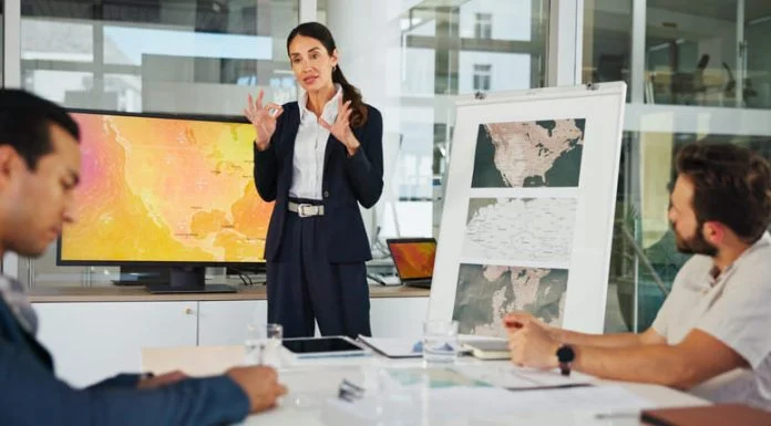 Presentation, Private Sector and map with team for weather pattern, seasonal trends and marketing geography. Whiteboard, meeting and speaker in office with screen, climate data and global campaign