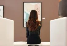 Reshaping the Art Market Through Independent Strategy and Legacy Planning Painting, curator and woman in art gallery, back and planning for exhibition of collection and thinking. Creative, conservator and person in museum for auction, contemplating and employee with vision