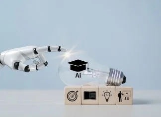 Employers Everywhere are Using AI ā but Business Schools arenāt Preparing Students for theĀ Shift A hand with a light bulb, artificial intelligence (AI) learning, educational tools, video-based instruction, digital courses, internet lessons, e-learning concepts.