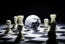 Geographic Strategy - Glass globe on chess board