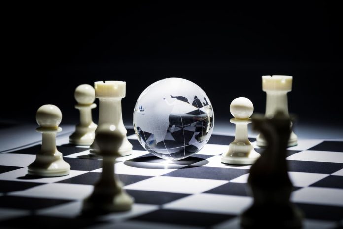 Geographic Strategy - Glass globe on chess board