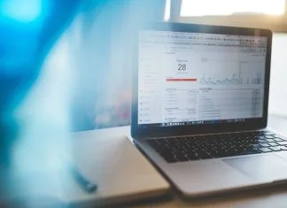 Quality Score: The Invisible Factor that Determines Your Cost Per Click Quality Score and cost per click display on laptop