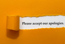 Please Accept Our Apologies Written Under Orange Torn Paper