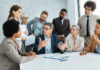 Young business people meeting office teamwork group success corporate senior mature colleague together. Leadership Behaviour concept