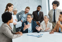 Young business people meeting office teamwork group success corporate senior mature colleague together. Leadership Behaviour concept