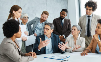 Young business people meeting office teamwork group success corporate senior mature colleague together. Leadership Behaviour concept