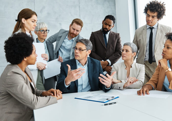 Young business people meeting office teamwork group success corporate senior mature colleague together. Leadership Behaviour concept