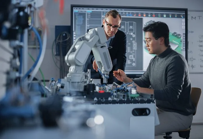 Concentrated Teacher Helping Asian Engineer Student Working with Screwdriver and Computer Motherboard. Science, Robotics and Engineering Concept at Modern University of Technology. Medium Shot China embodied AI