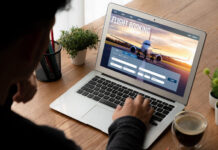 Should Business Travelers Book Flights Before Their Visa Is Approved? Businessman booking a flight online
