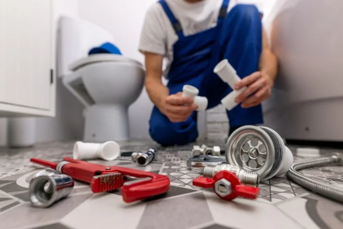 plumber working in bathroom. plumbing services Bathroom sink repair tools