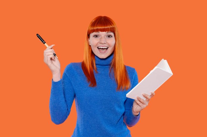 Choosing Promotional Pens - holding a notebook and pen
